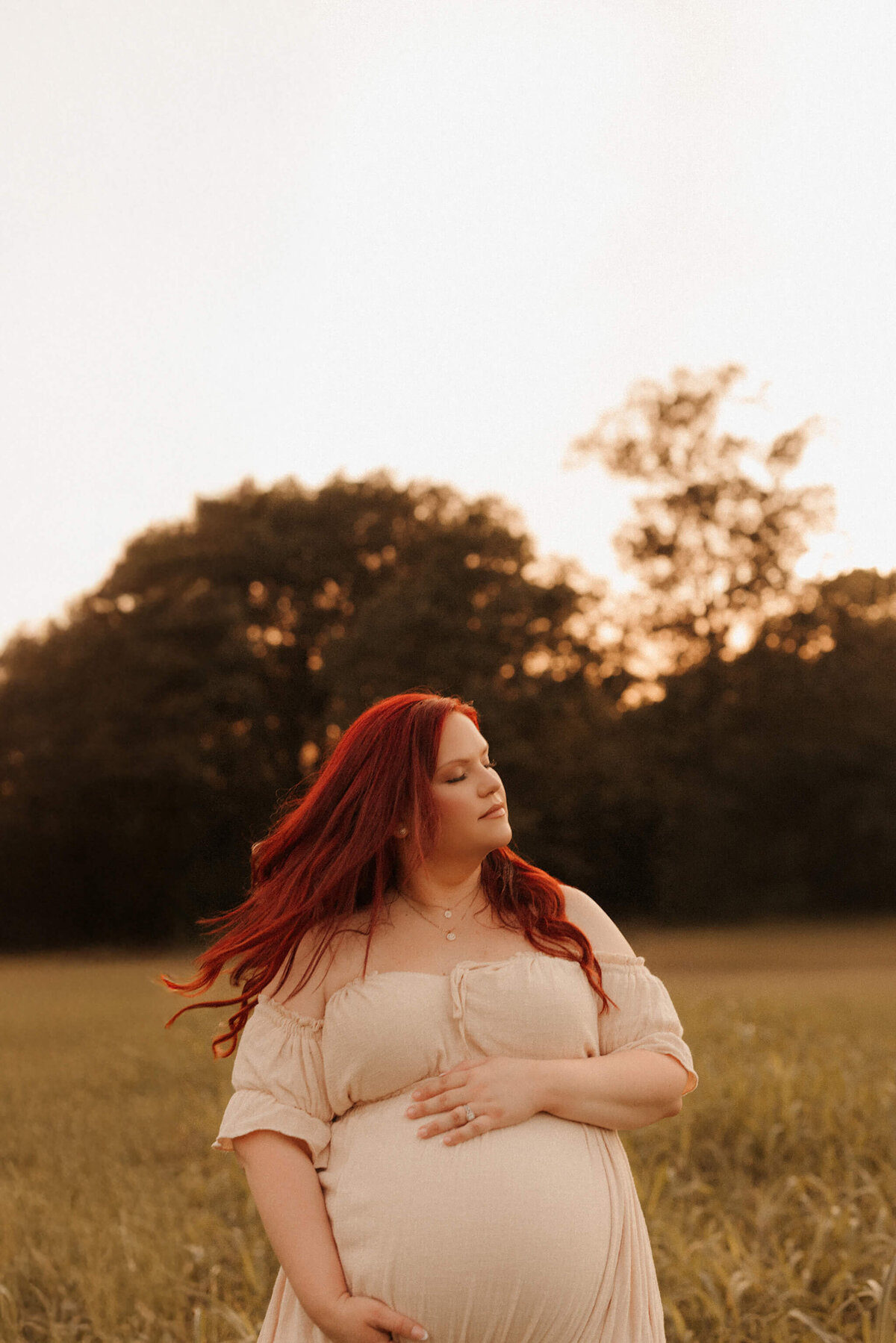 Pregnant woman in cream gown during Franklin Tennessee maternity session