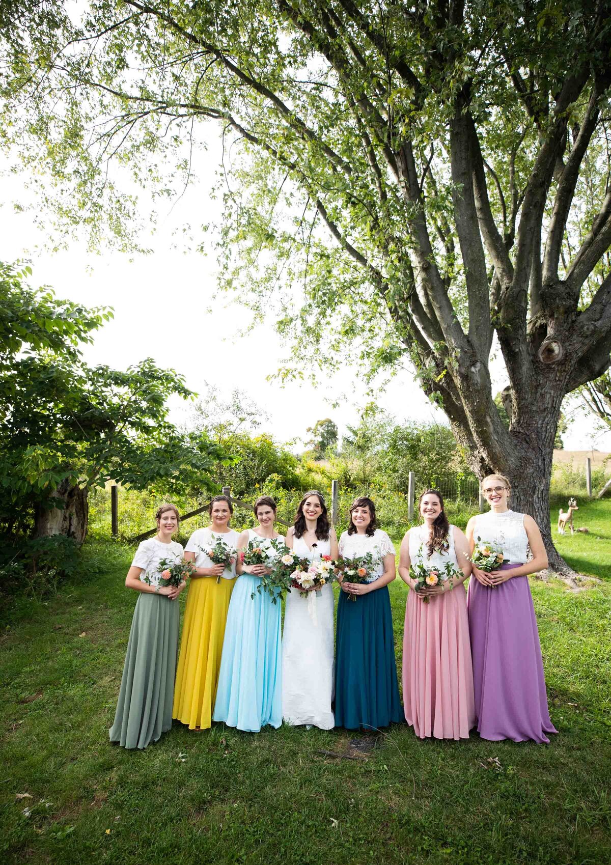 bridal party with different pastel colored skirts