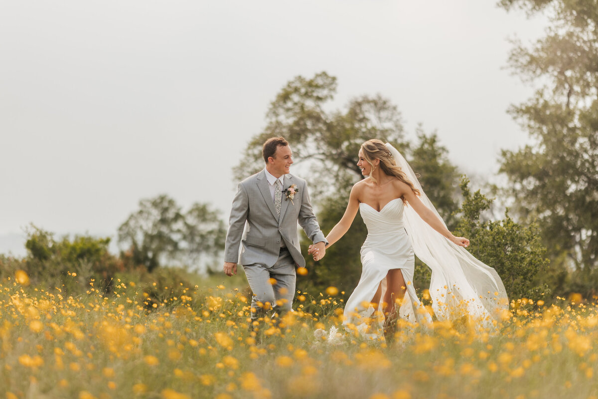 bride-and-groom-run-through-wildflowers