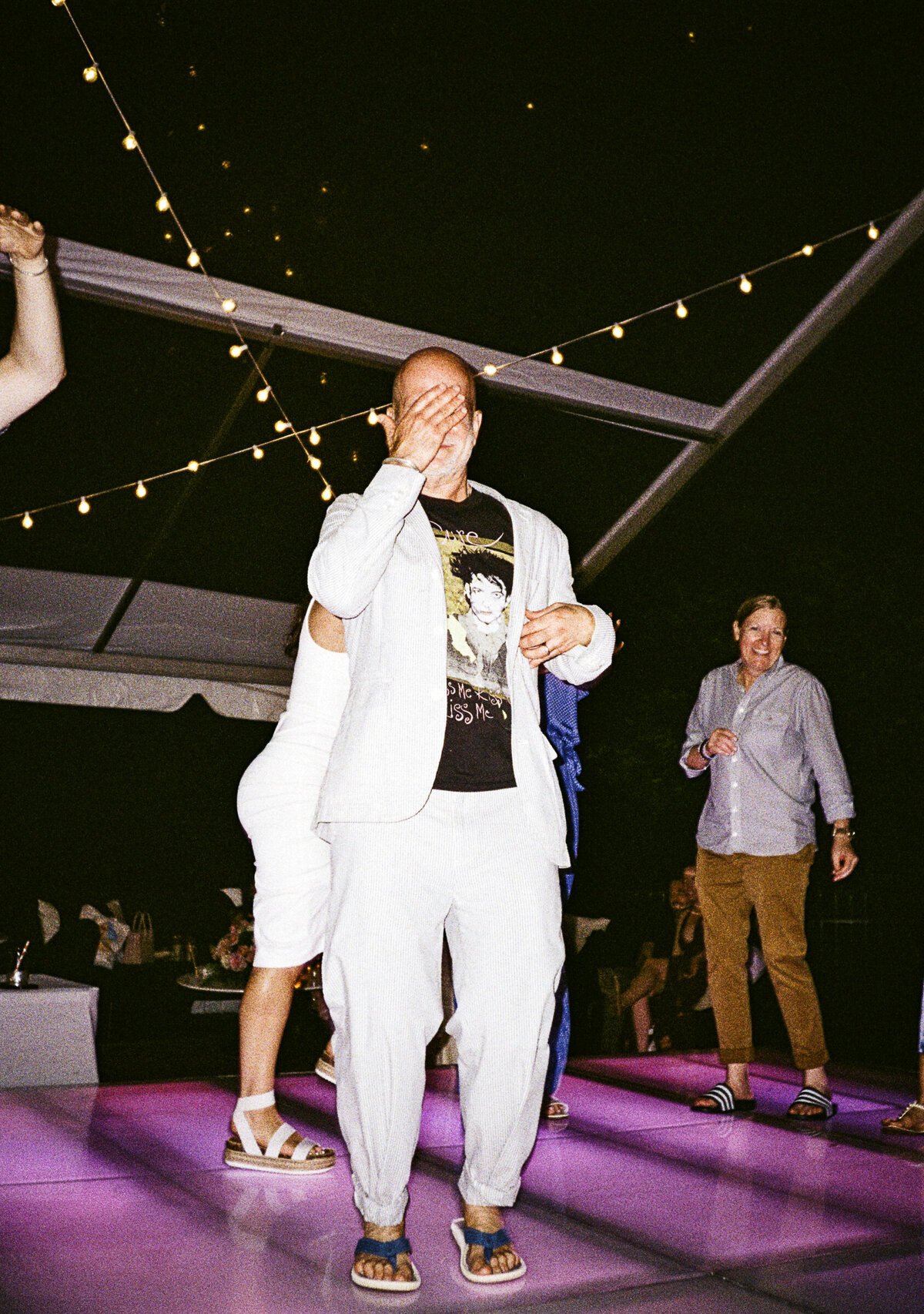Photo of guest on neon pink dance floor on film in private backyard party by Mira Park Photography NY based wedding photographer
