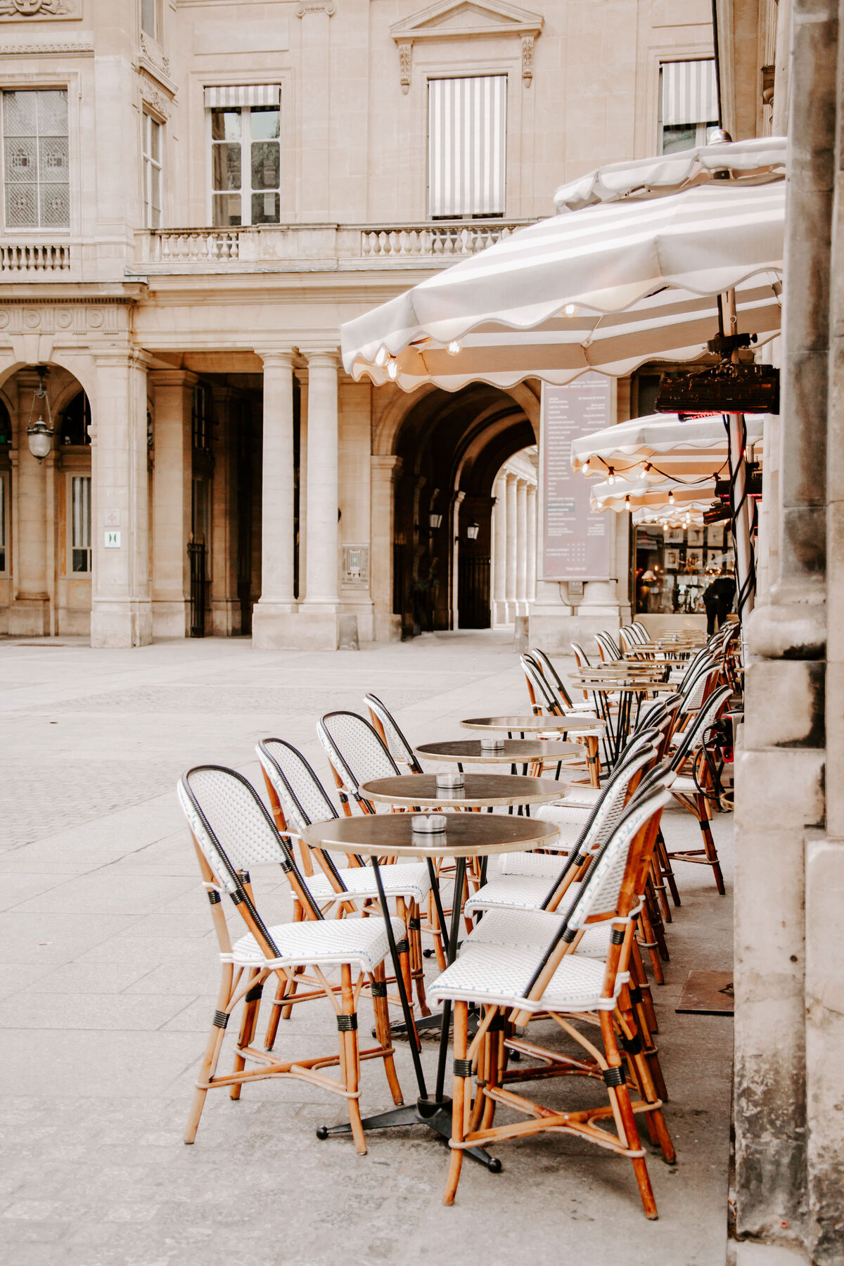 Outdoor dining tables and chairs under umbrellas