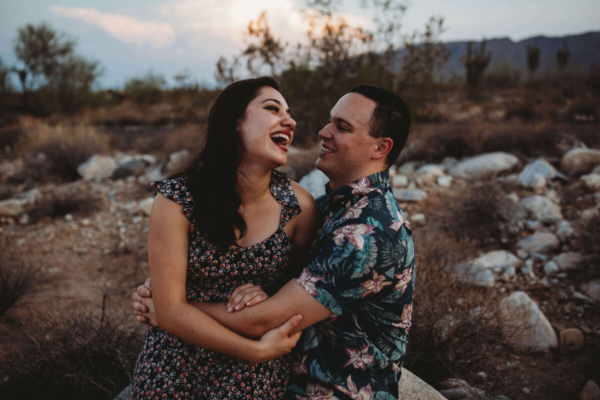 Owner and husband, couple hugging and laughing during portrait session outdoors