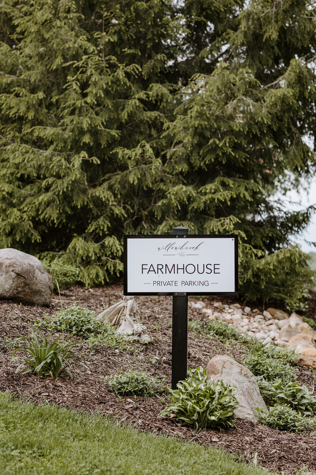 the sign for the modern farmhouse overnight accommodations at Willowbrook wedding venue