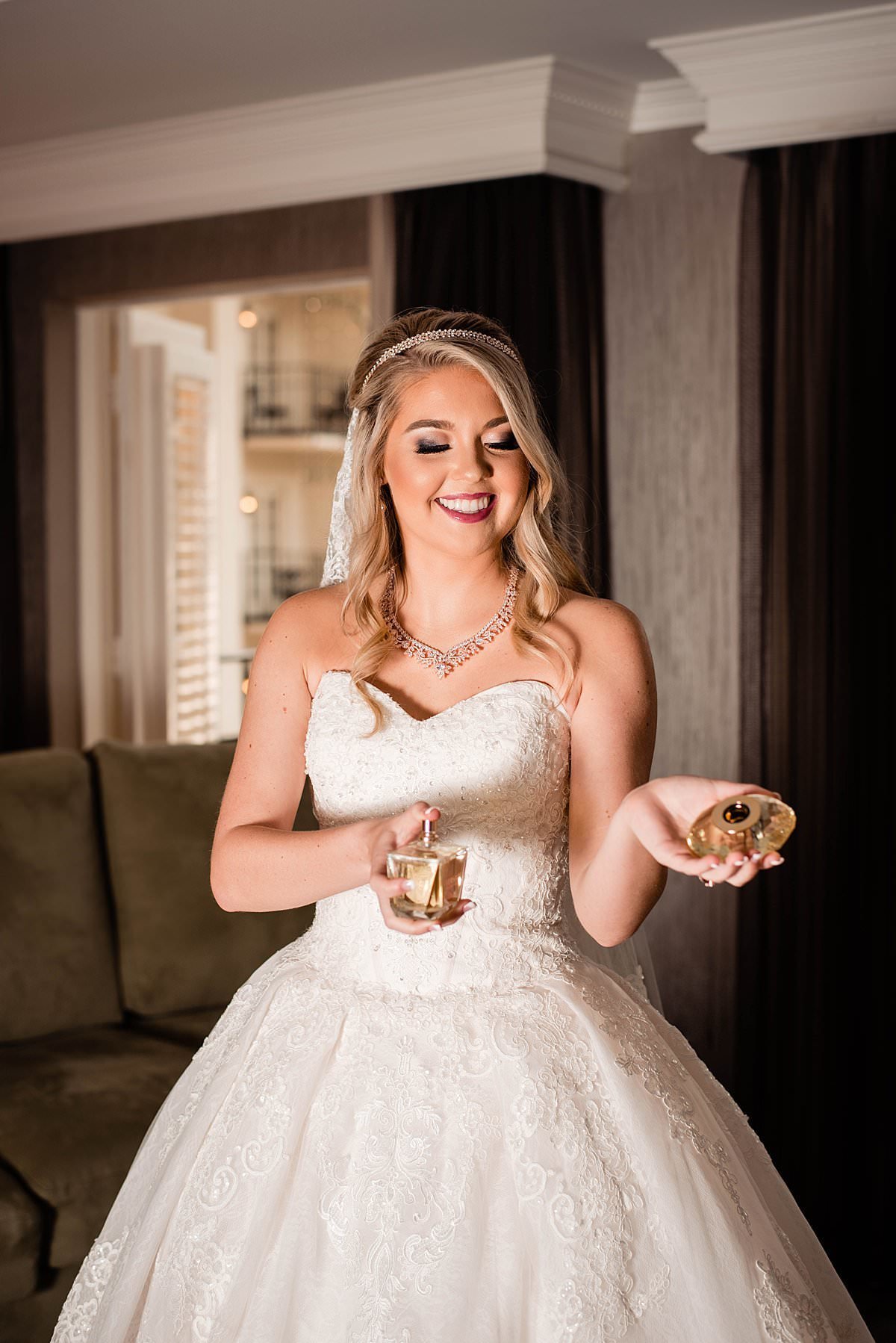Bride putting her perfume on