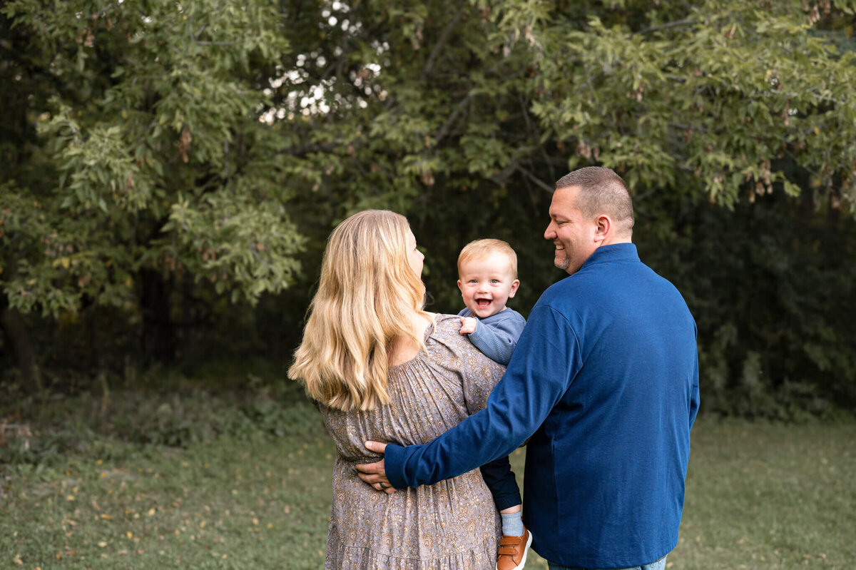 family cuddling together in nature for a photo