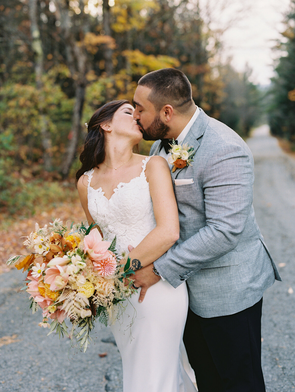 bride and groom kissing at fall wedding in Franconia New Hampshire
