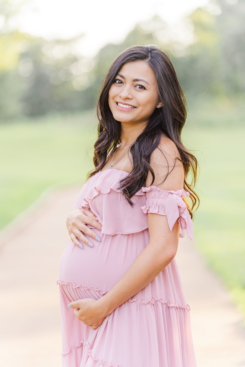 smiling expecting mom during a maternity mini session in Vienna, Virginia