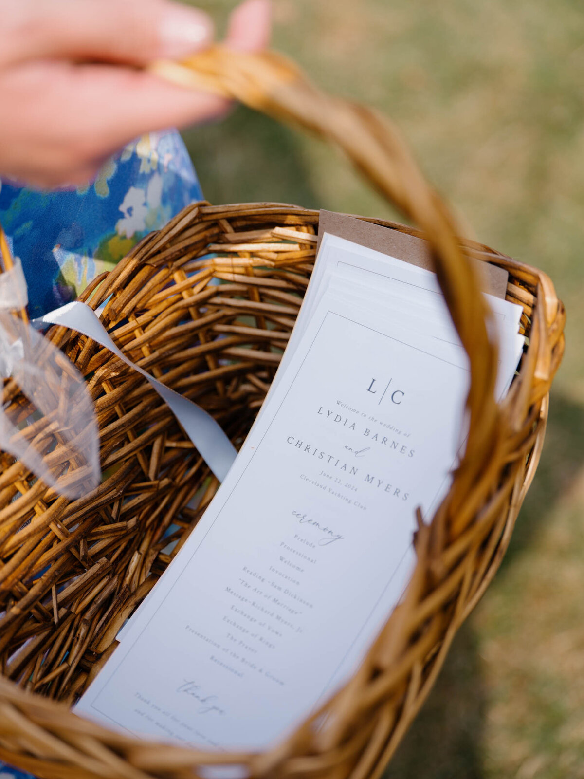 Wedding ceremony programs in a basket at Cleveland Yachting Club