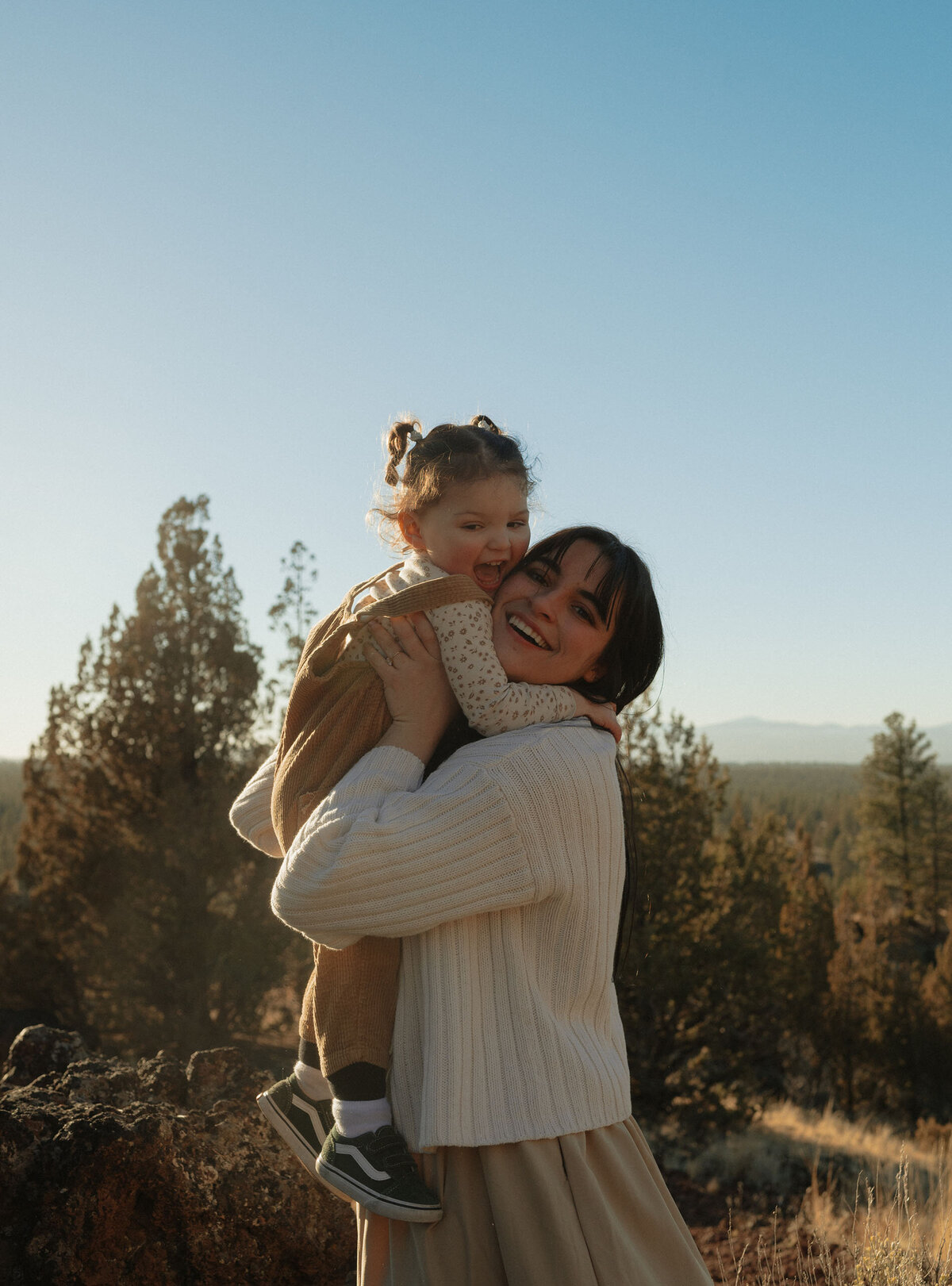 mother and daughter laughing and playing in the outdoors in Bend Oregon