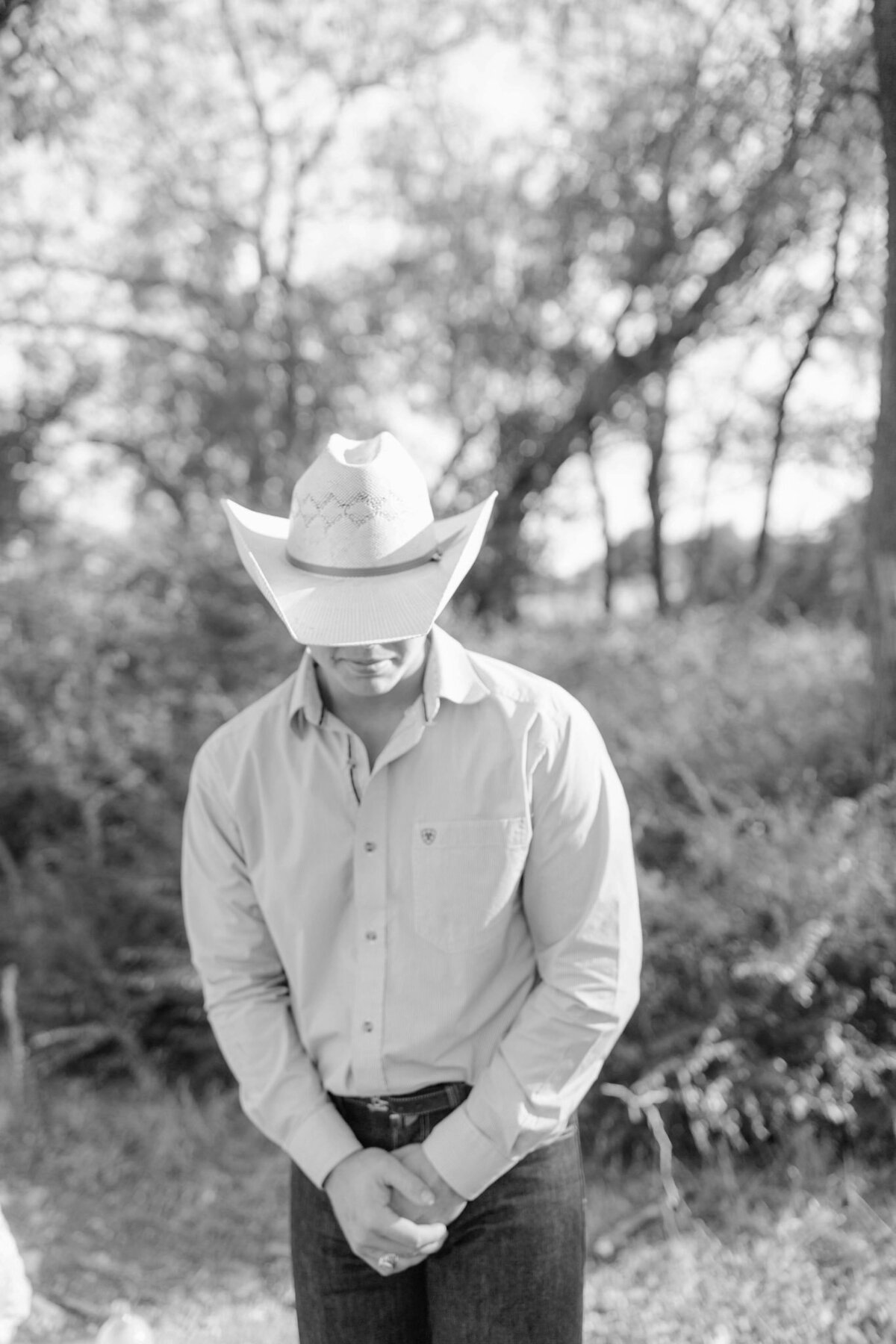 black and white photo of groom in cowboy hat