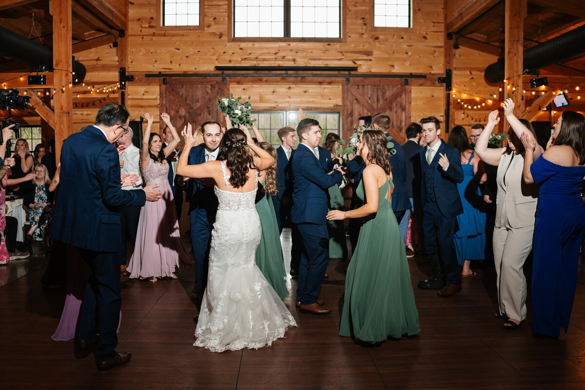 Elegant reception setup with candles, florals, and wooden tables