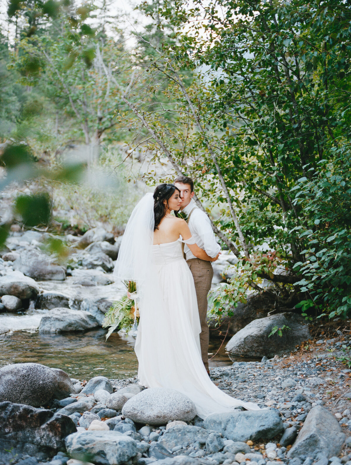 Bride and Groom in the forest next to a creek