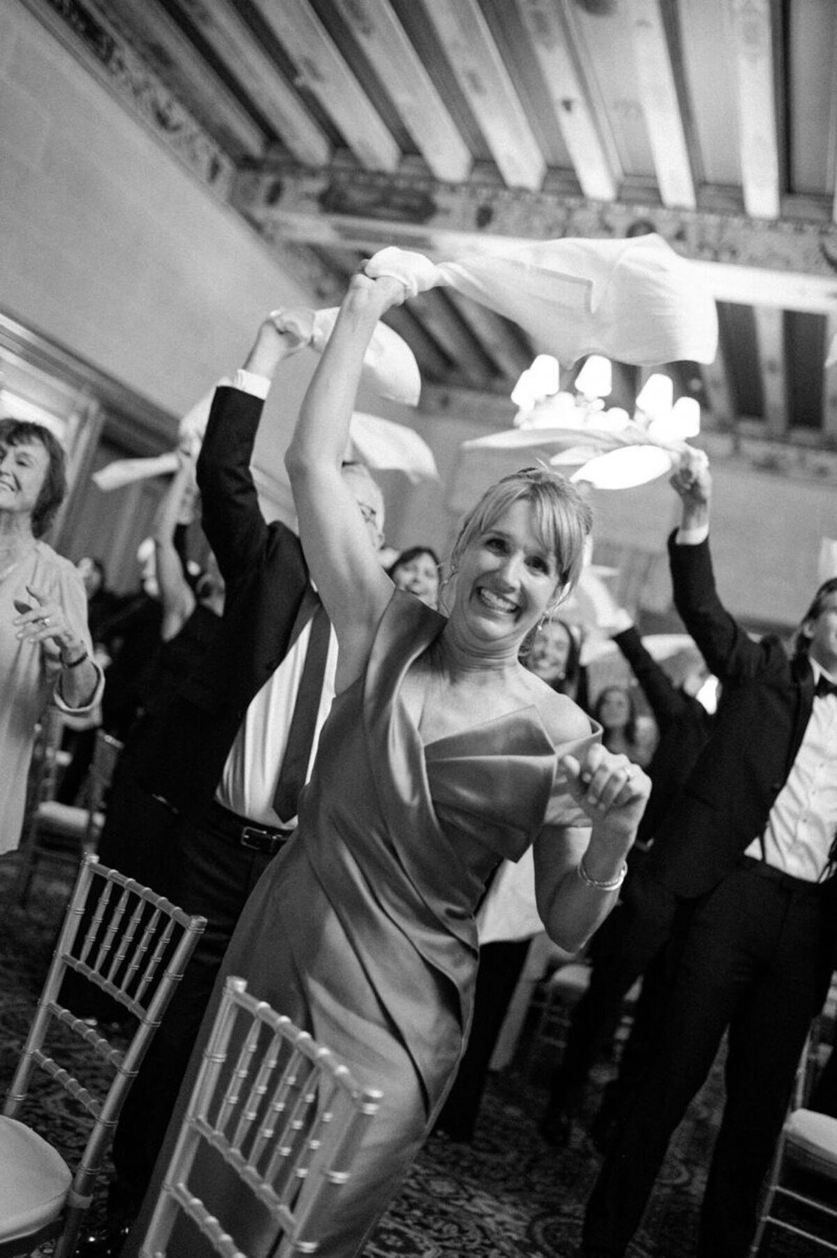 Wedding guests cheering at Detroit athletic club wedding, captured by Detroit Michigan wedding photographer​ Courtney Rudicel