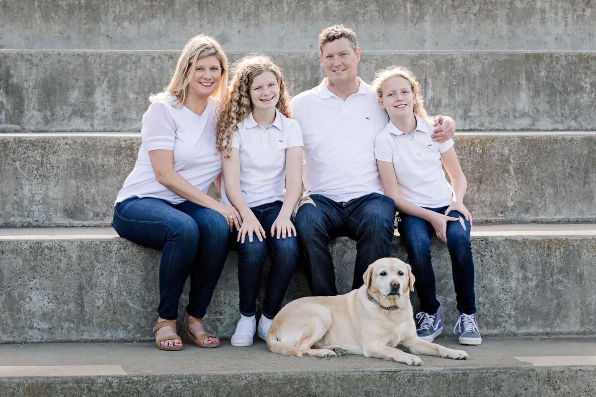family with dog on steps