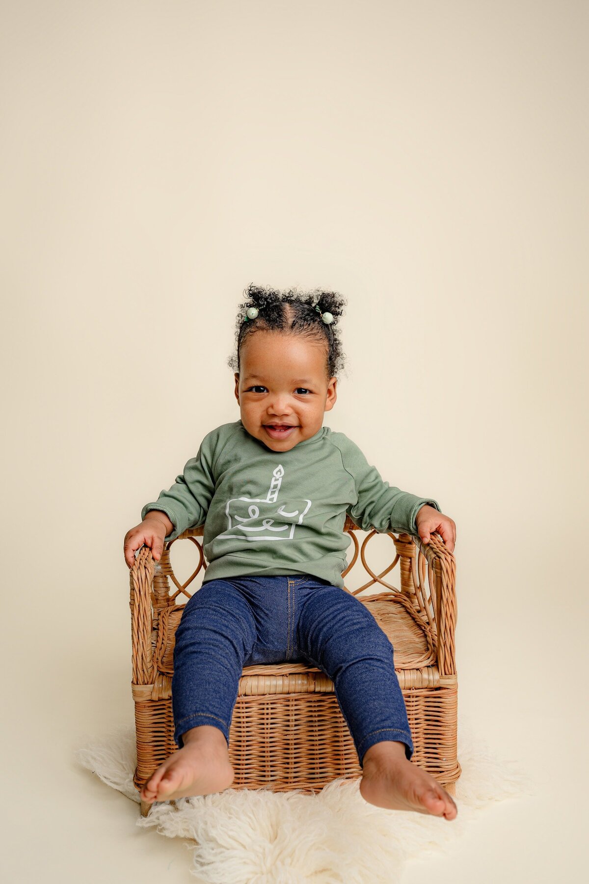 girl sits in green shirt and jeans sitting on brown bench