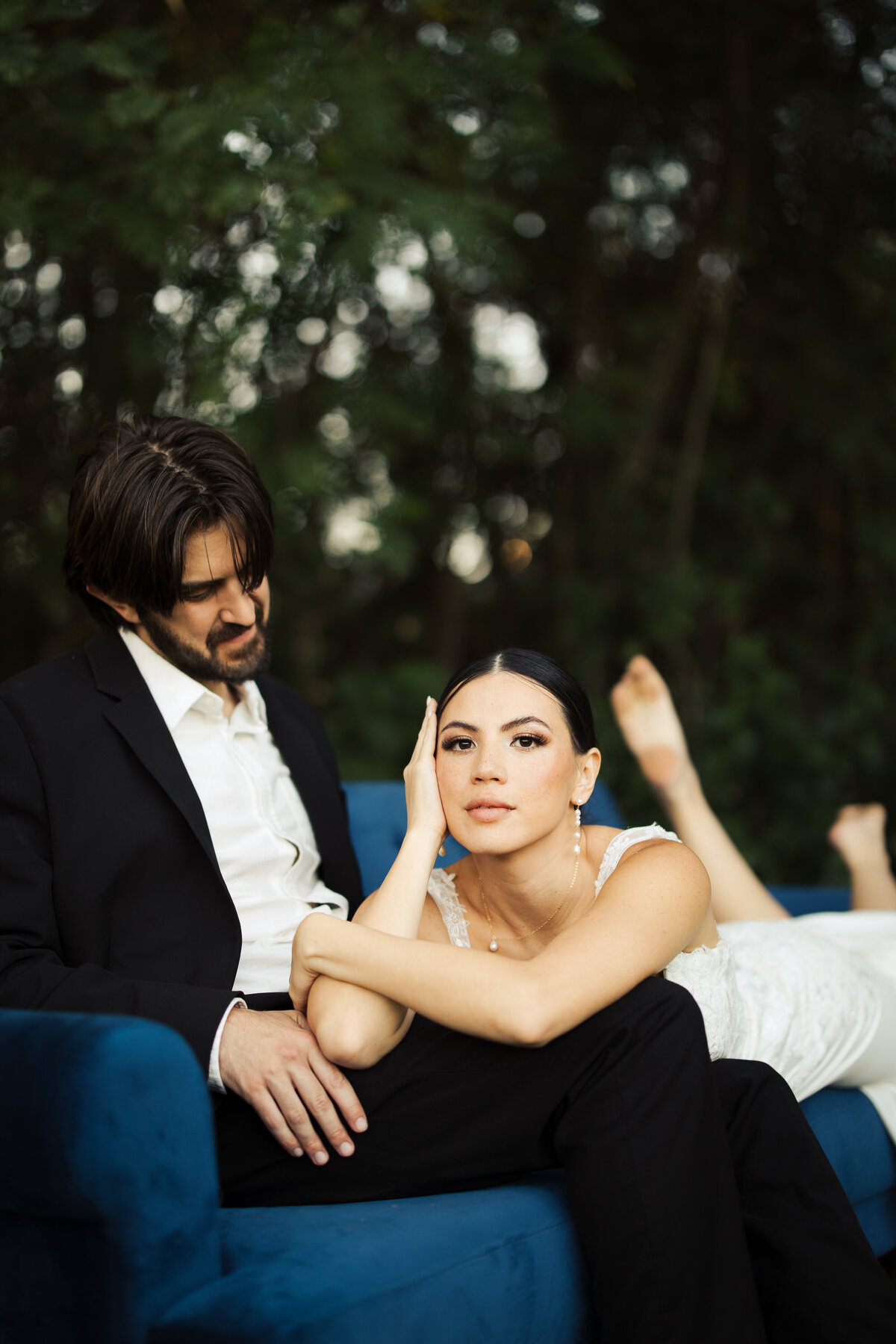 Bride and groom laying on a couch