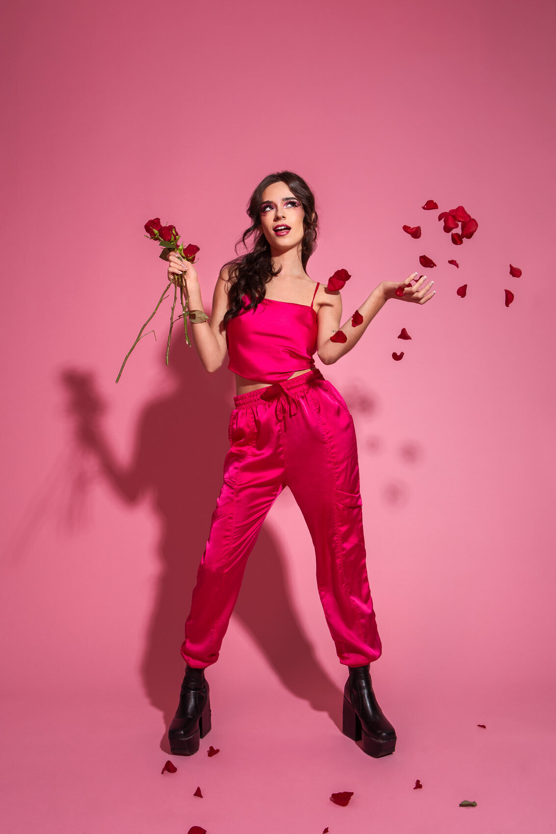 Vibrant portrait of Sofia Dubois in a pink suit against a matching background, photographed by Ylva Erevall.