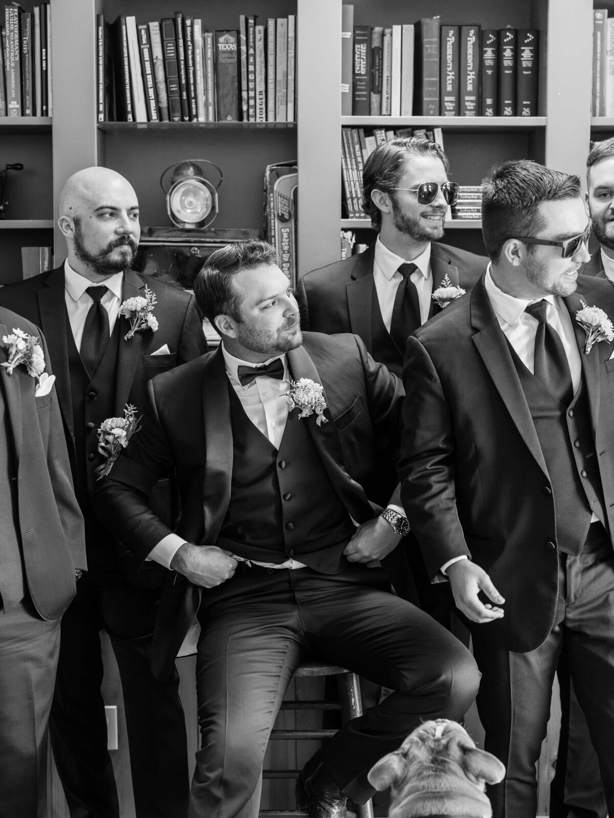 A groom poses with the men in his wedding party, representing the little moments he and his groomsmen enjoy together.
