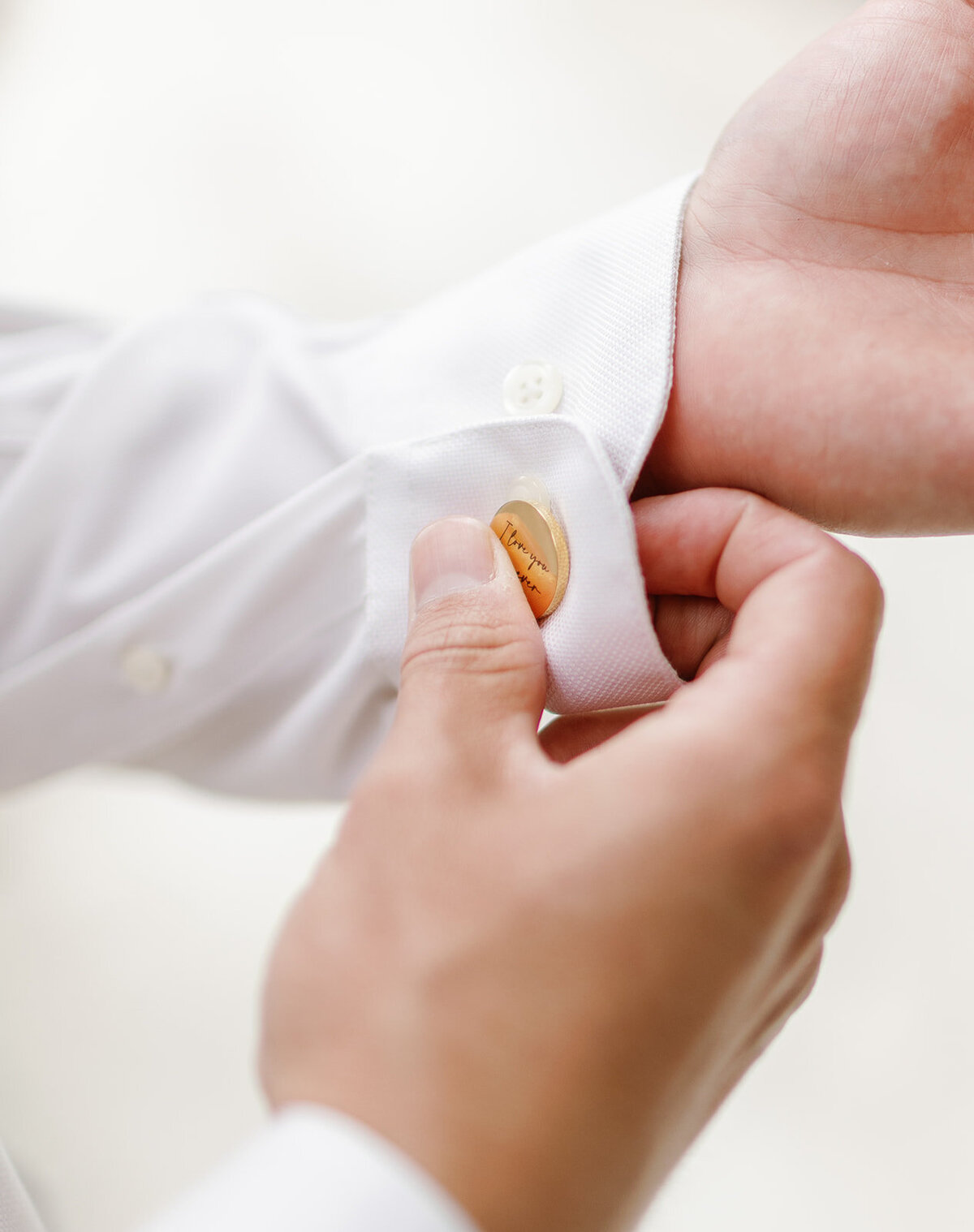 Stephen fastening his cufflinks before the wedding at Cheeca Lodge. Claudia Amalia Wedding Photography.