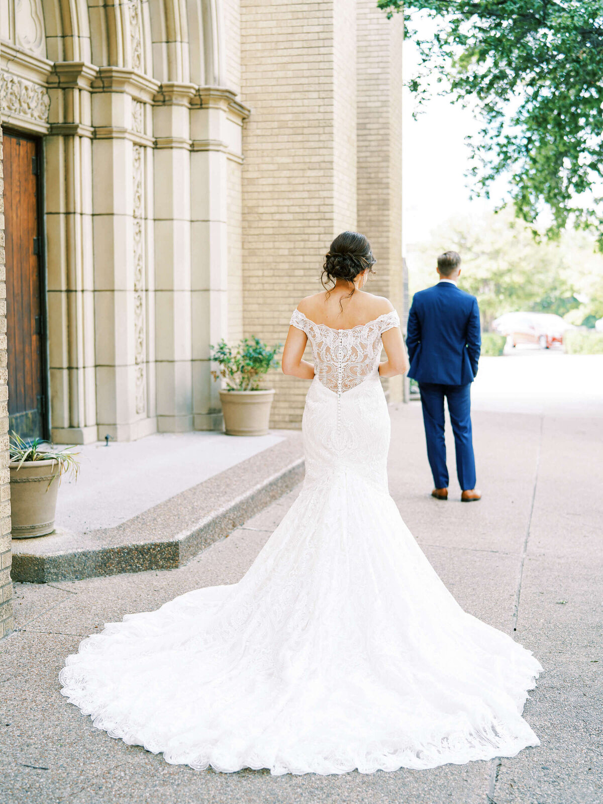 Bride approaches groom outside wedding chapel in Fort Worth