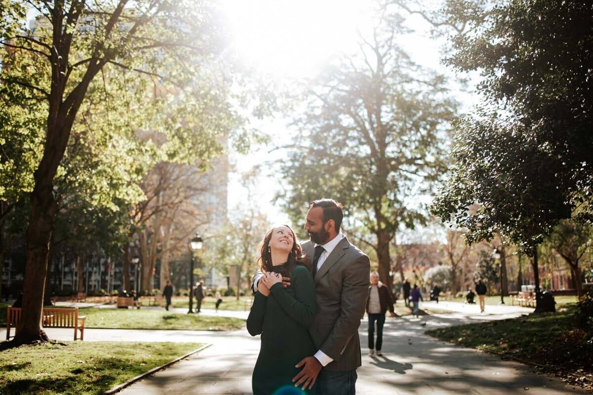 Couple standing on the path staring into each other's eyes while embracing each other in Philadelphia.