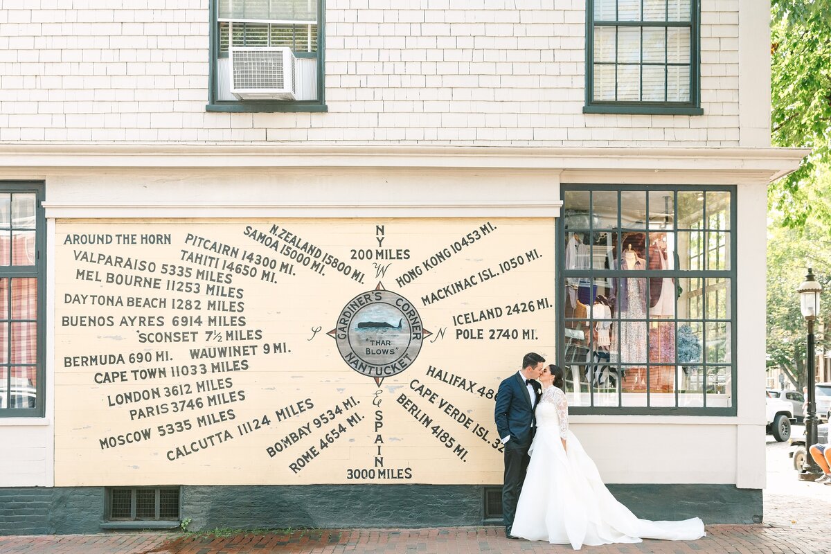 bride and groom near painted wall compass in nantucket