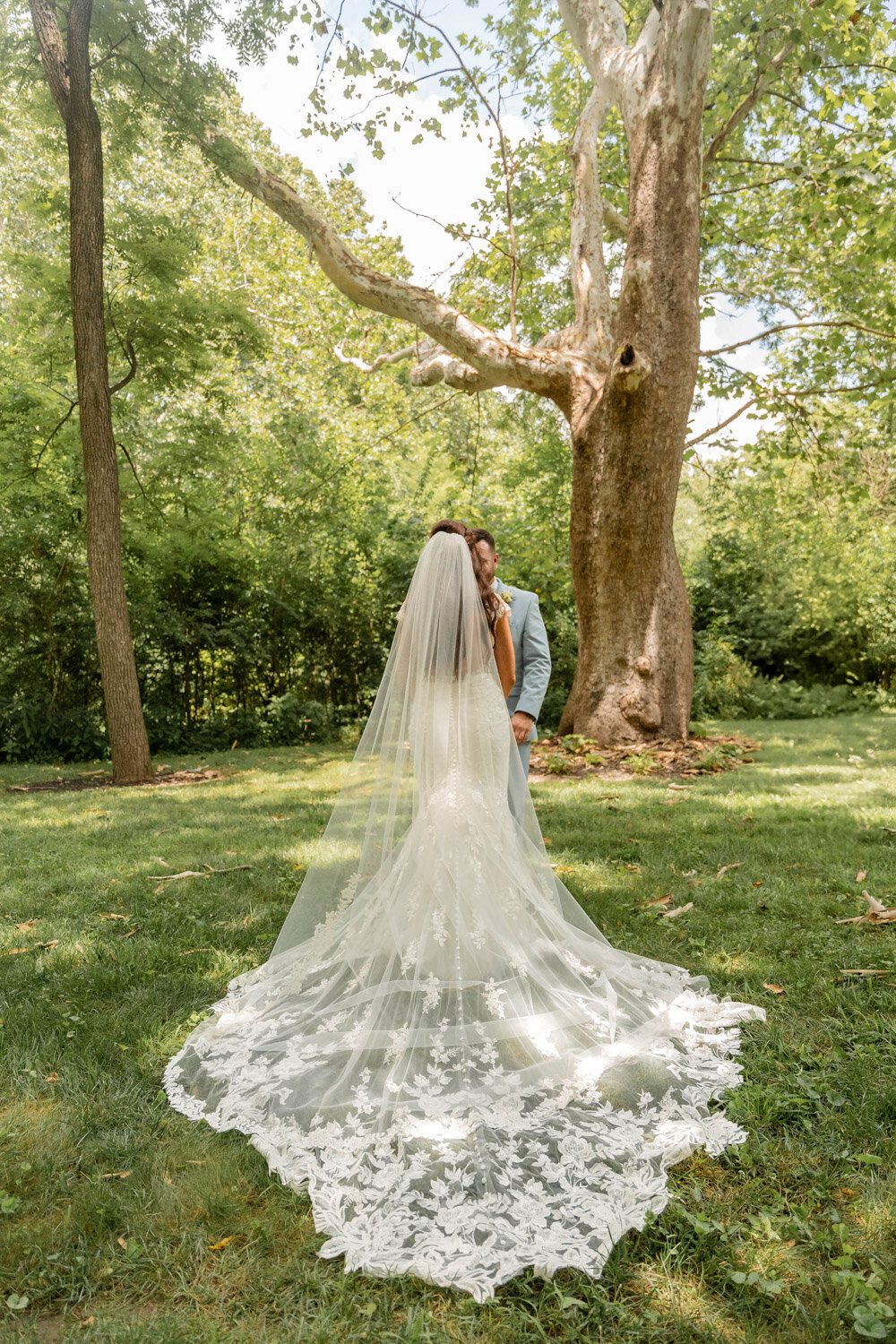 Bride walking outside wearing elegant wedding gown