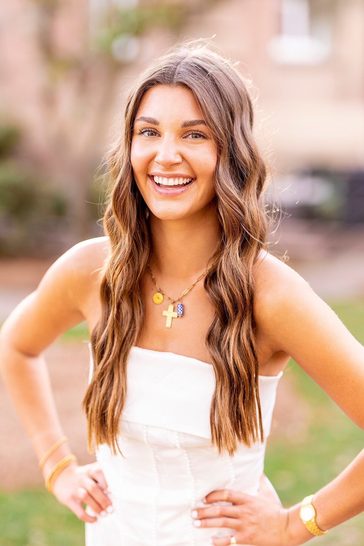 College of Charleston senior smiling joyfully in the Cistern Yard during her senior portraits