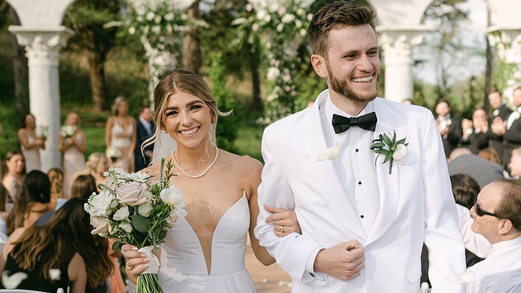 Husband and Wife walk down the aisle together after getting married