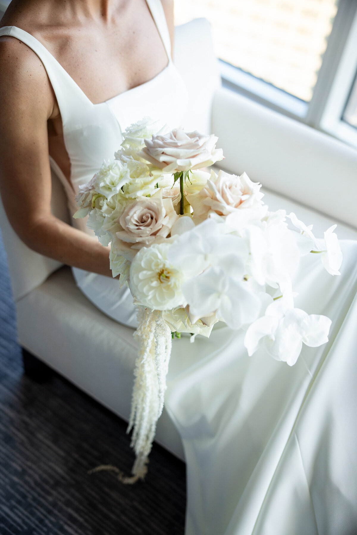 A picture of brides hands holding a white flowers