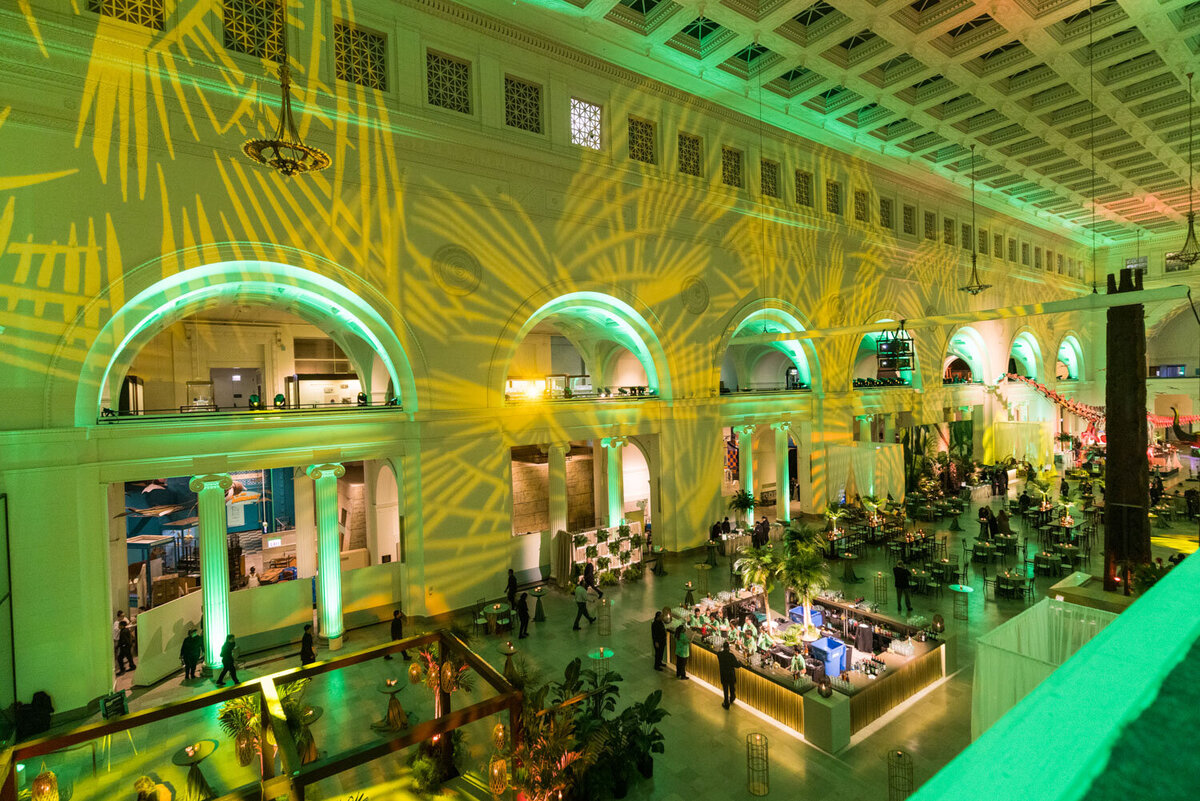 Wide view of large event hall with green lighting