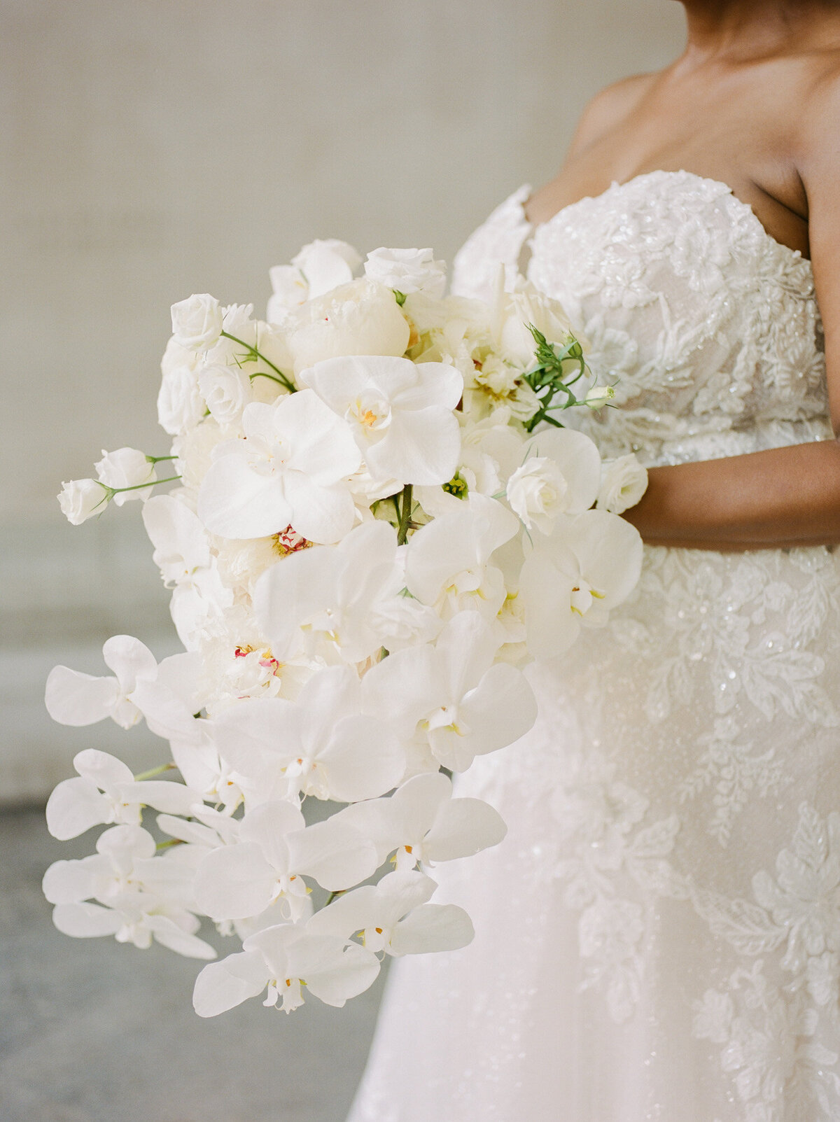 ethereal white orchid and rose wedding bouquet, bridal bouquet captured by film wedding photographer Christina Harrison in Detroit