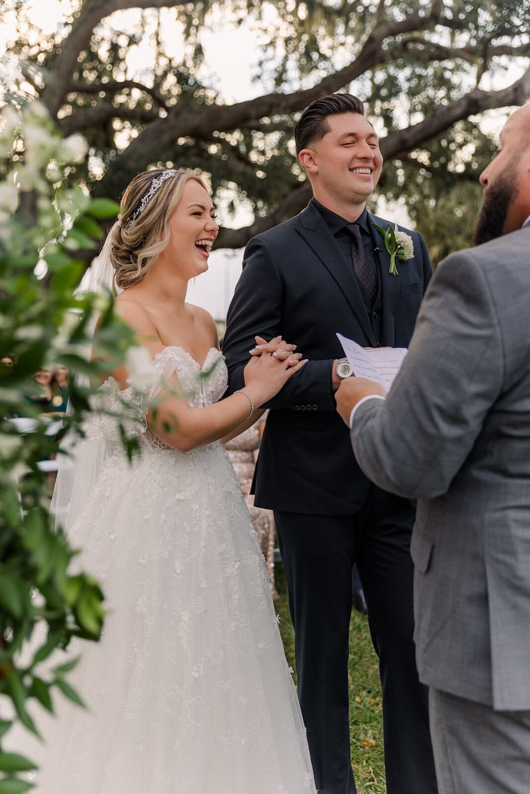 Bride and Groom laughing during ceremony at Bella Cosa, Lake Wales, Florida