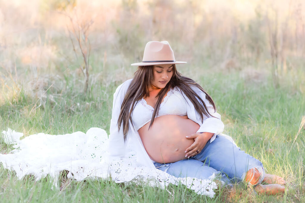 Mom holding baby bump during maternity session at Fisher Farm Park