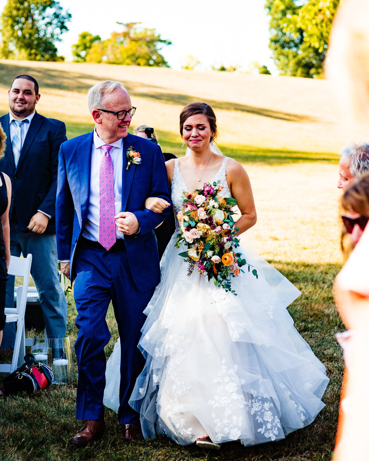 One of the top wedding photos of 2020. Taken by Adore Wedding Photography- Toledo, Ohio Wedding Photographers. This photo is of a bride crying as her father walks her down the aisle at Nazareth Hall in Toledo Ohio
