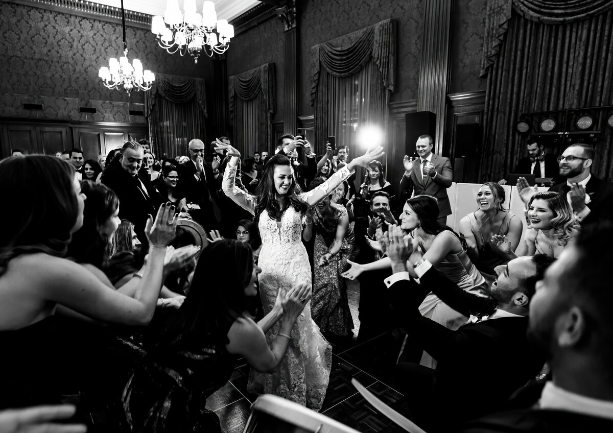 A bride dances with everyone cheering at her Union Club wedding.