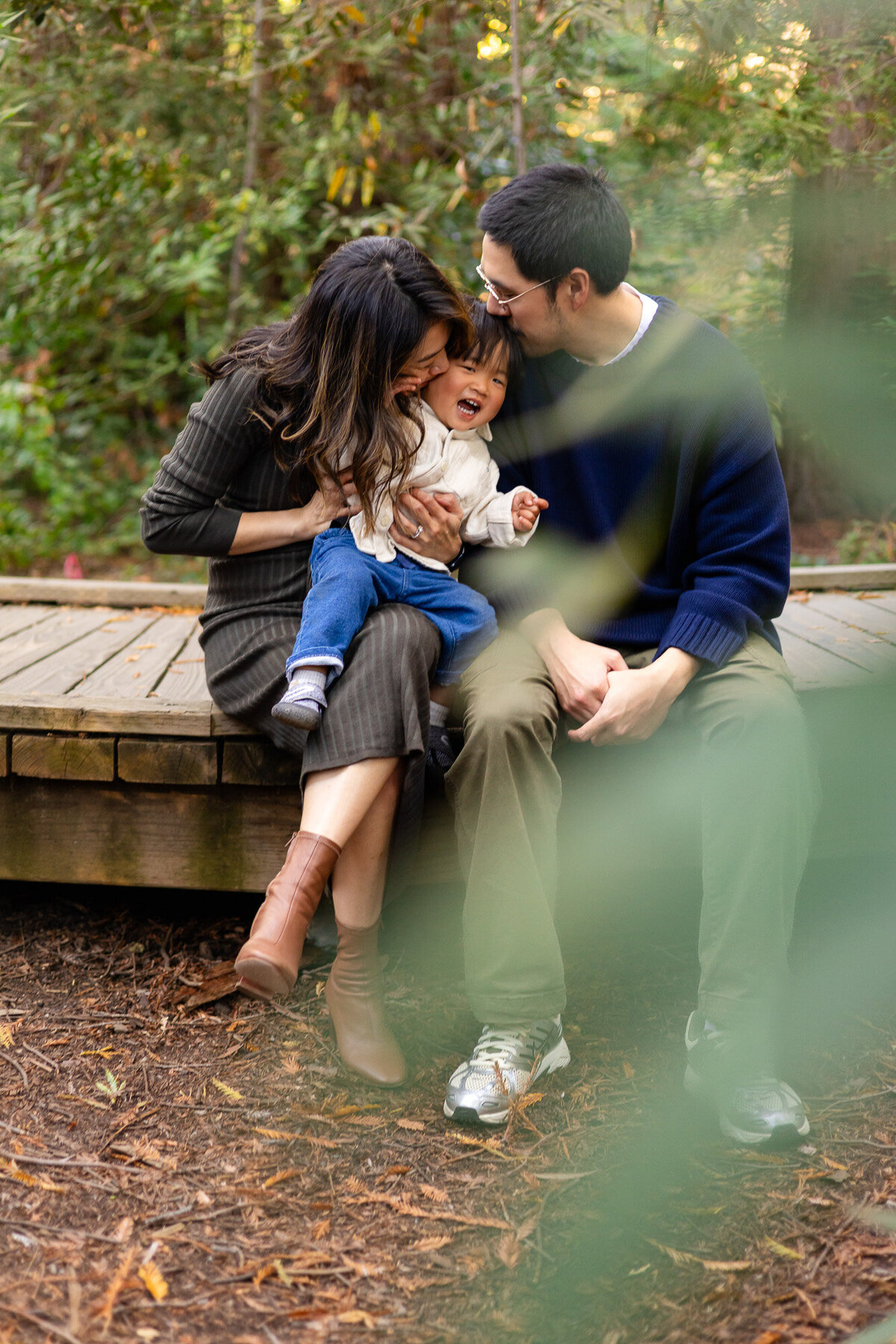Family cuddling and laughing together on wooden deck outdoors – Bay Area Family Portfolio | Ellobelle Photography