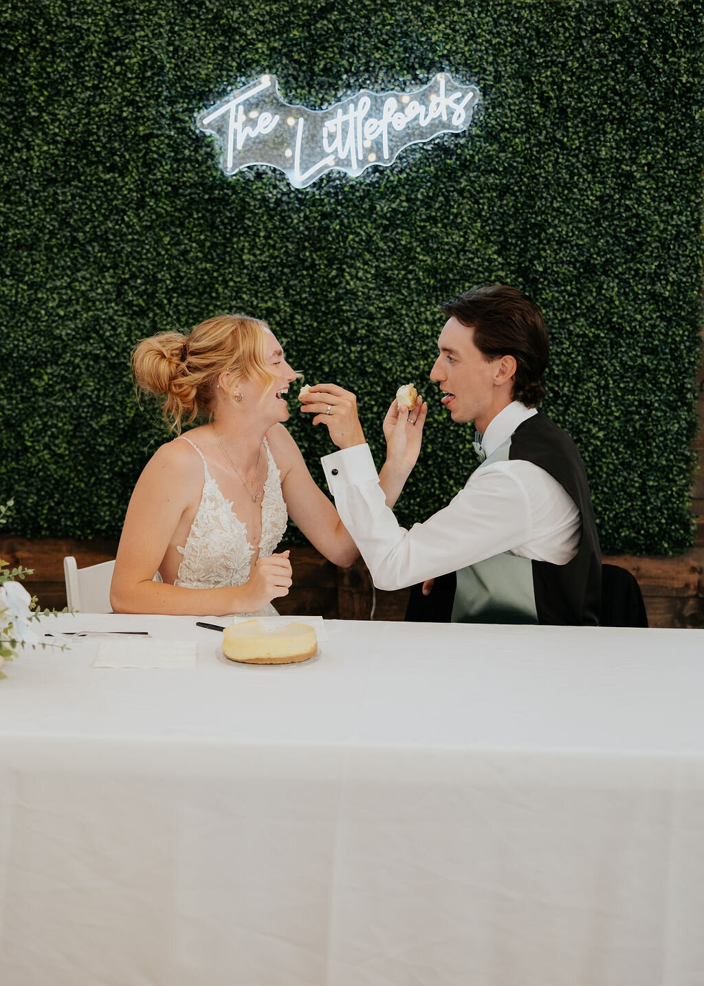 Couple sharing cake at the sweetheart table