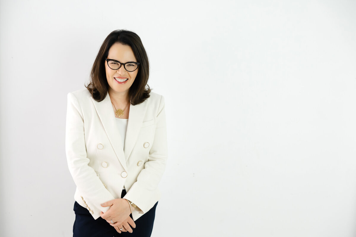 Leadership coach smiling confidently promoting the Do Stress Better approach for success