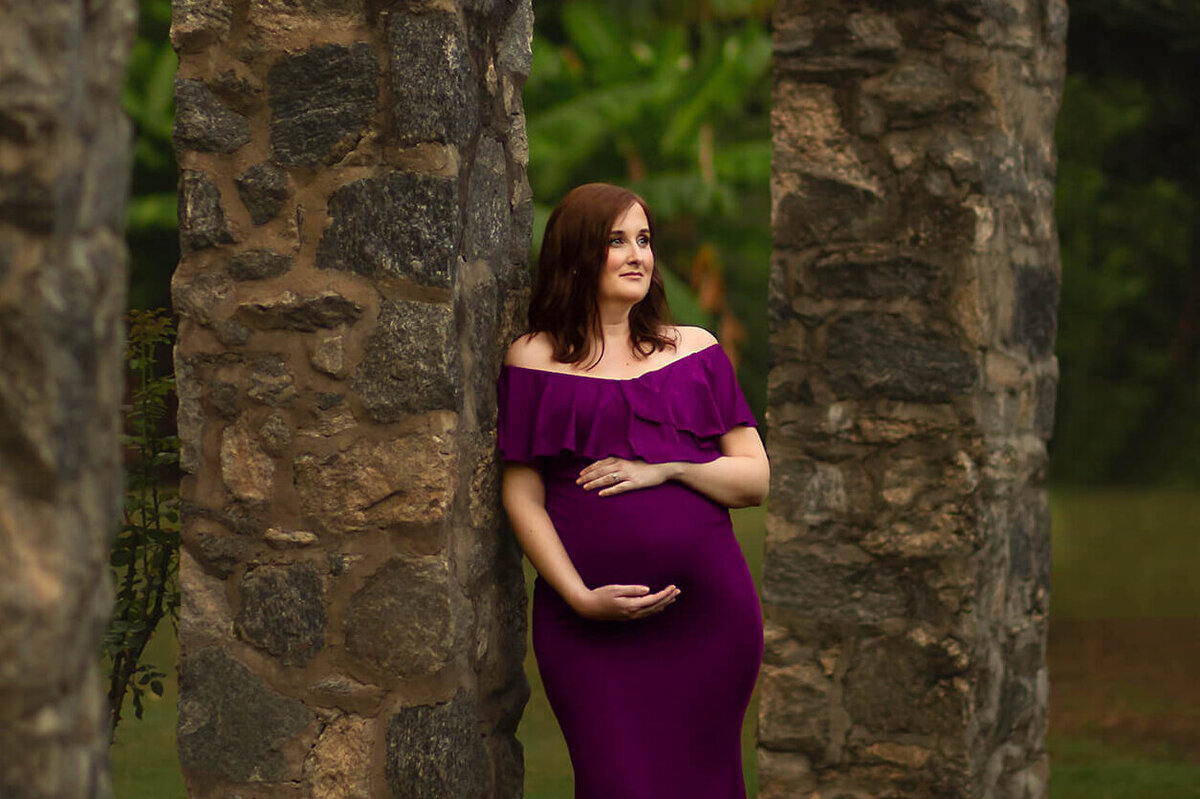 Pregnant woman at Raleigh Rose garden enjoying her maternity photography