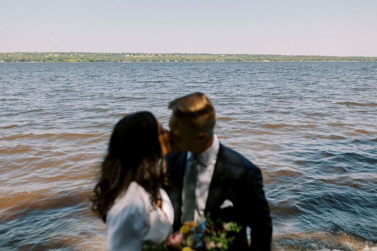 An intimate and romantic elopement at Constance Bay, featuring a serene beachfront ceremony with a breathtaking sunset backdrop. This elegant setup includes a chic floral arrangement and soft, glowing lanterns, perfect for couples seeking a secluded and picturesque elopement location