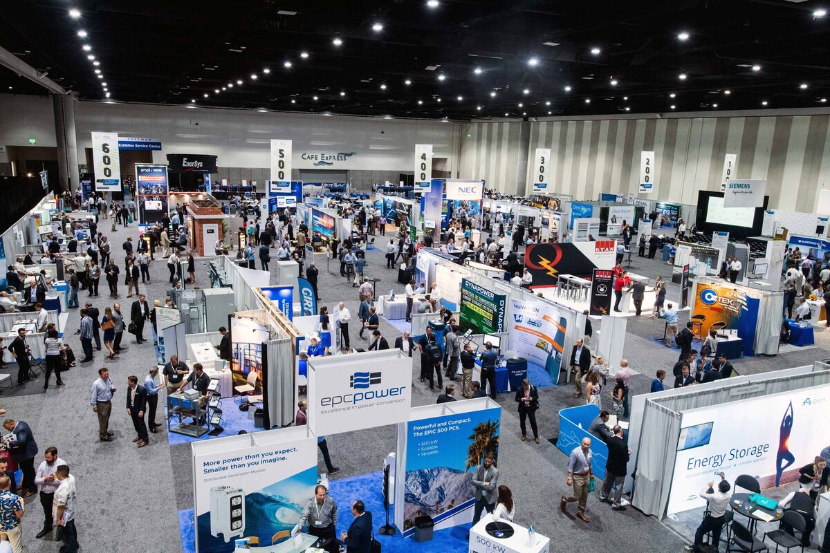 An overhead arial shot of a busy expo floor filled with people and booths