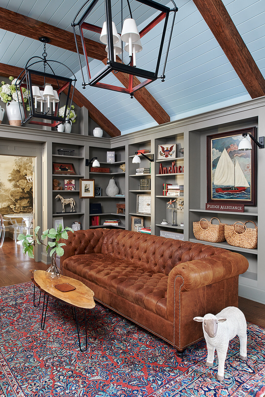 library room with built-in bookshelves and large brown sofa