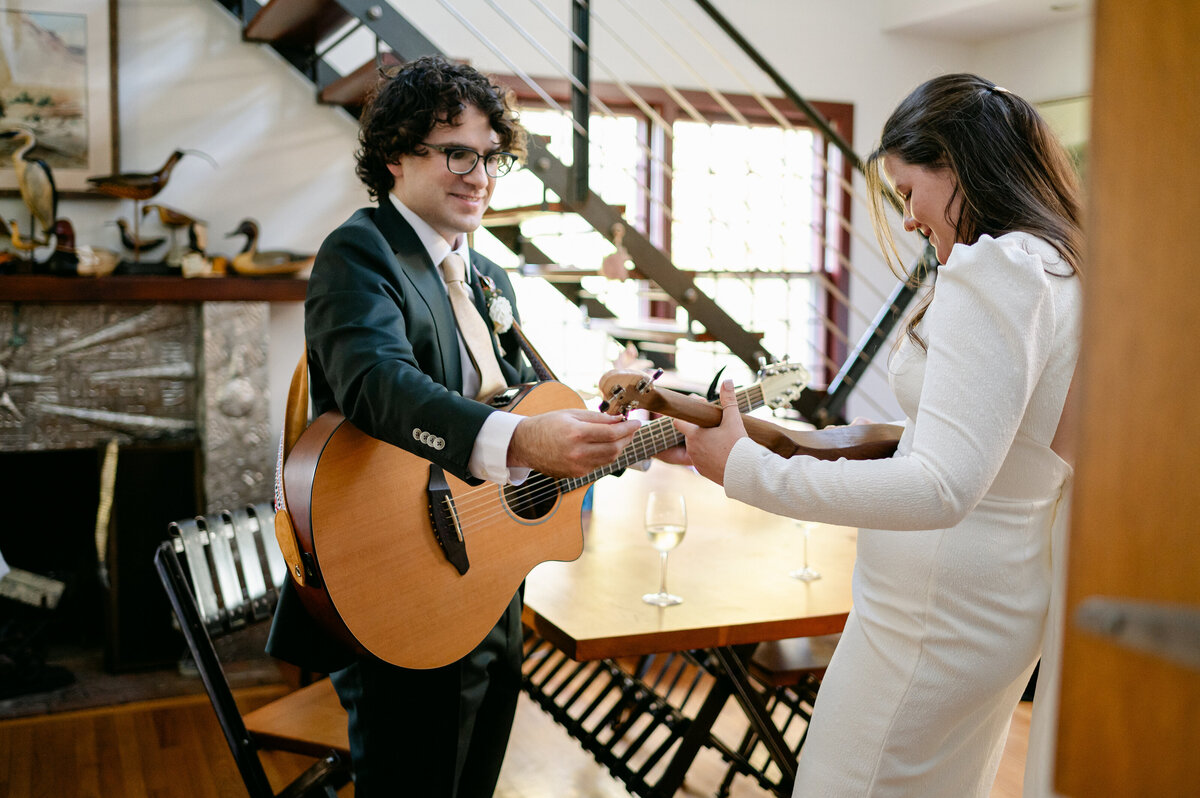 Bride and groom rehearsing with guitars before their wedding