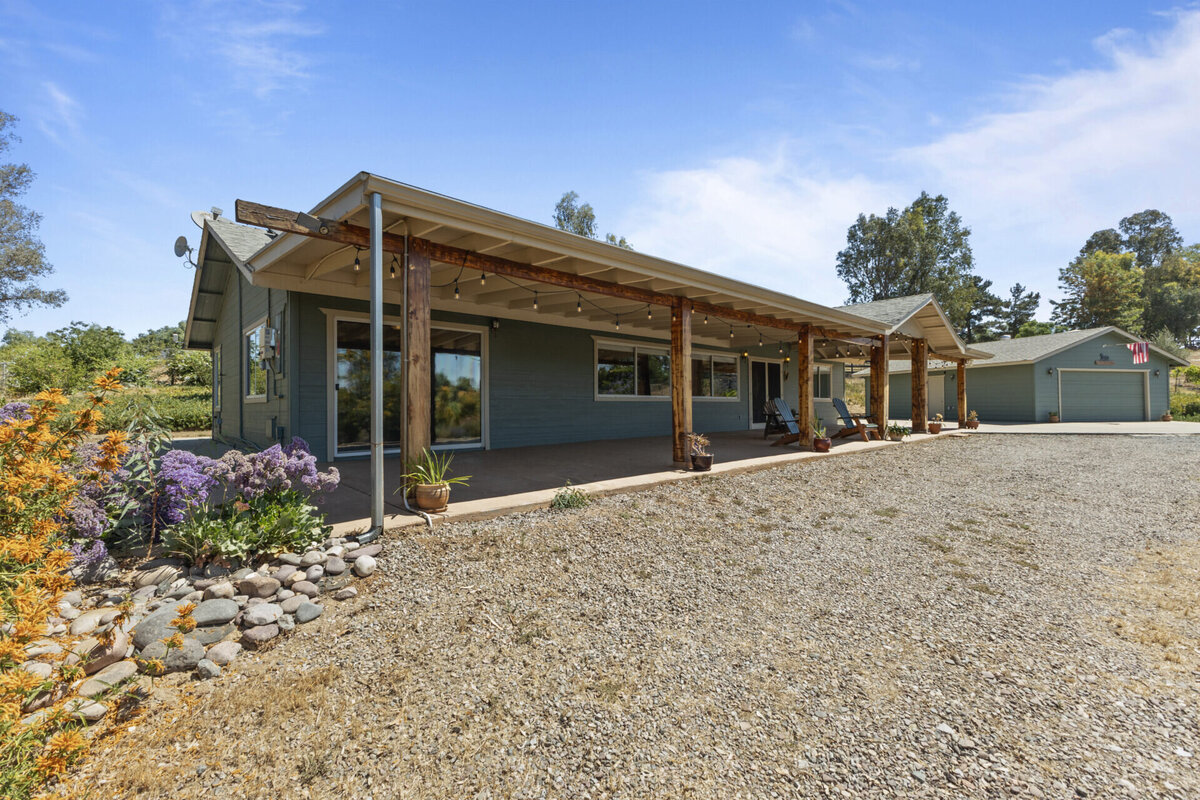 Front of dark green home with large porch. Real Estate home in Ramona