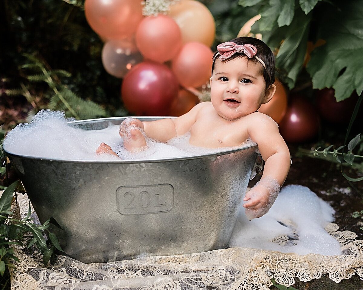 Adorable baby in bubble bath outdoors for baby pictures in Portland