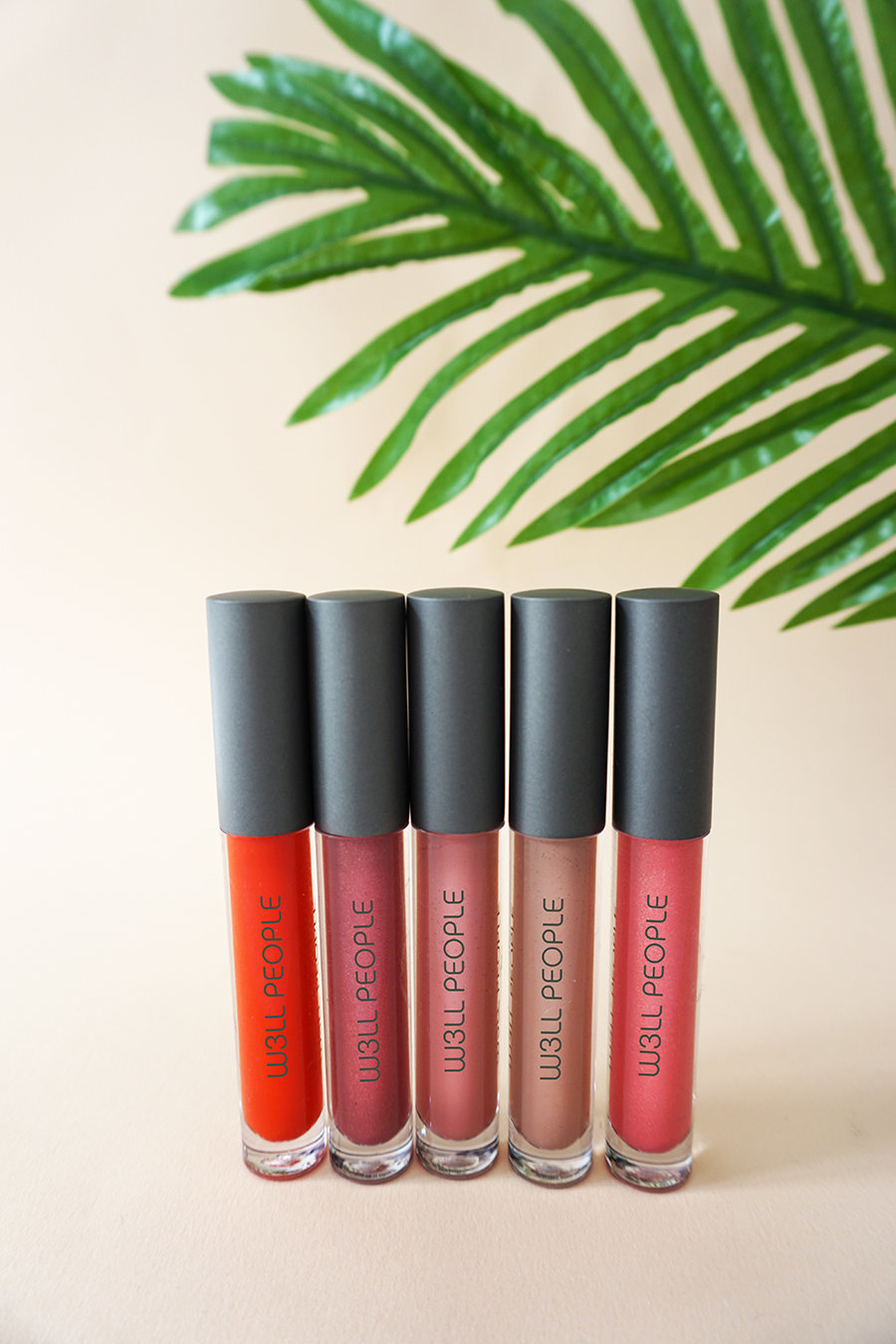 Bio Extreme Lipglosses on peach with plant