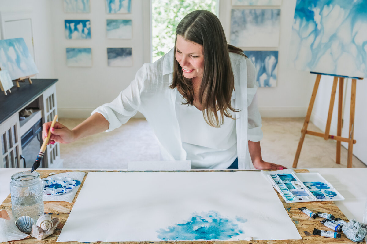 Jennifer water color painting in her studio
