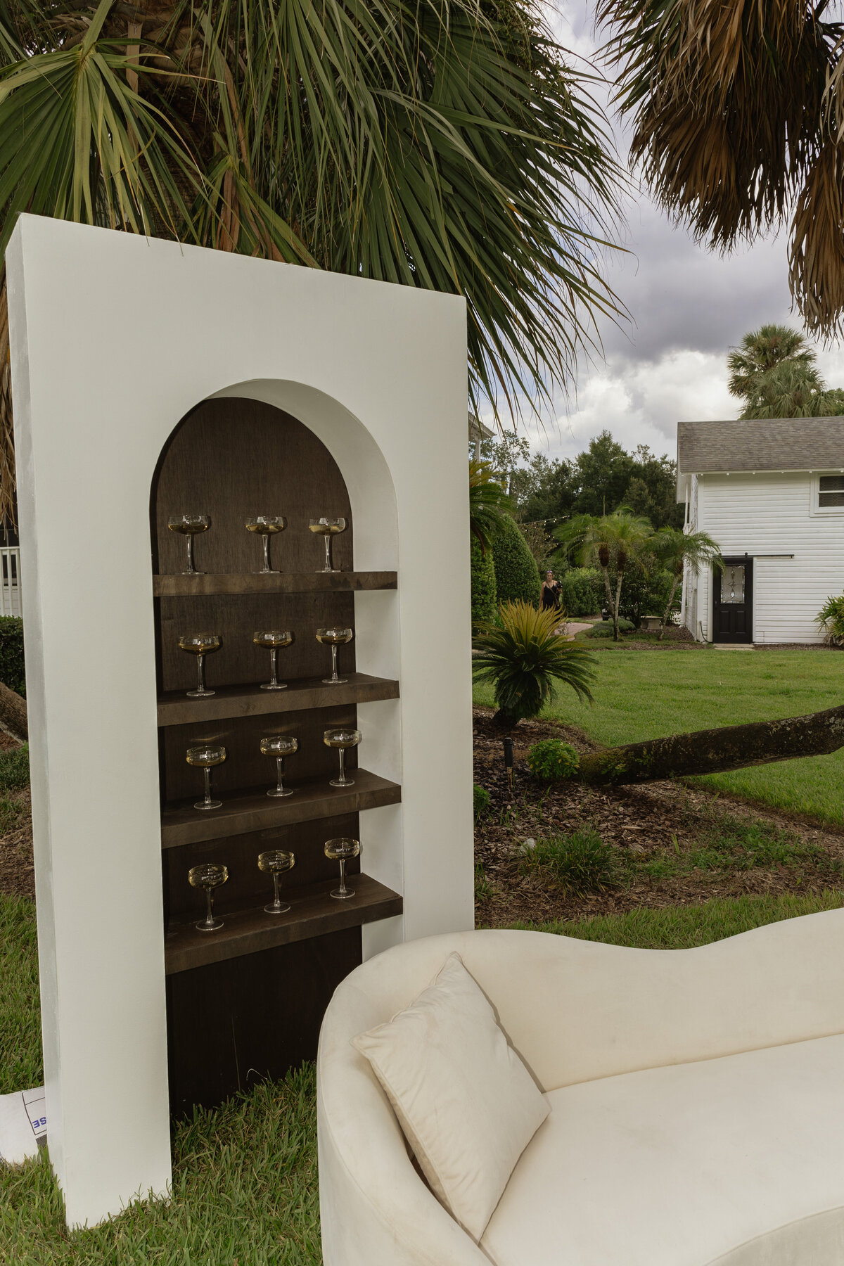 Champagne shelf display with gold accents at a luxury backyard wedding in Umatilla, Florida