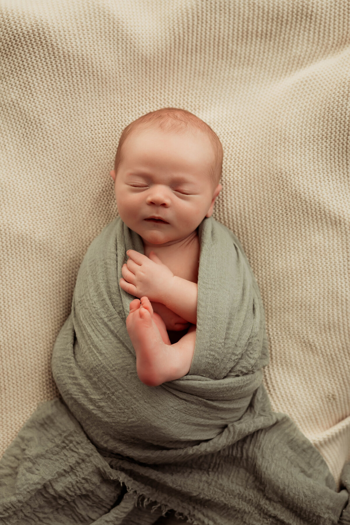 Newborn baby swaddled at an in home session in Busselton captured by south west and Perth photographer Kalie Creative